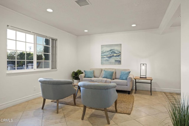 living room with light tile patterned floors, a textured ceiling, and ornamental molding