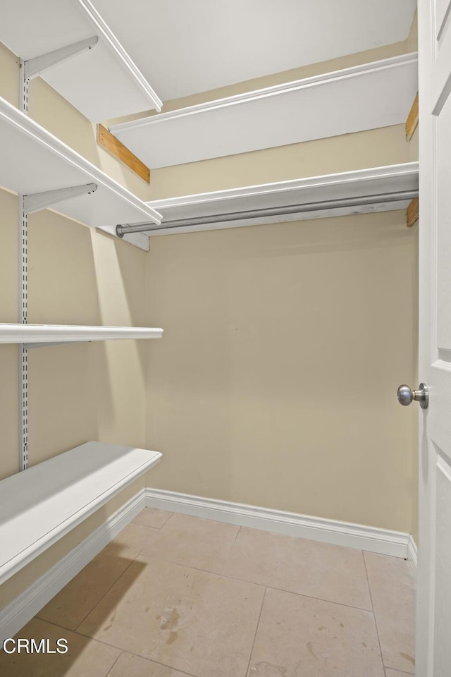 walk in closet with tile patterned floors