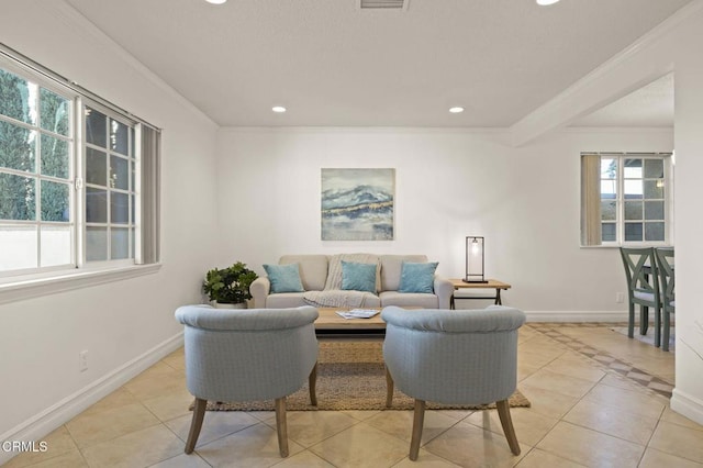 tiled living room with a healthy amount of sunlight and crown molding