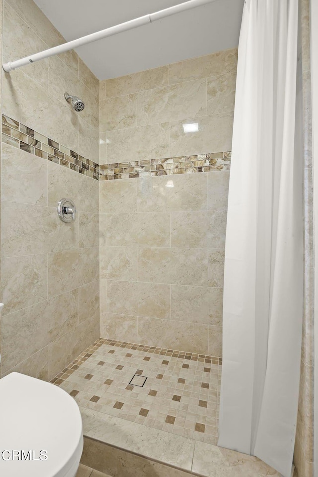 bathroom featuring toilet and walk in shower