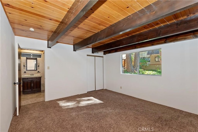 interior space featuring carpet, sink, wood ceiling, and beamed ceiling