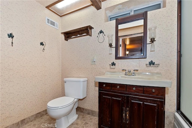 bathroom with tile patterned flooring, vanity, and toilet