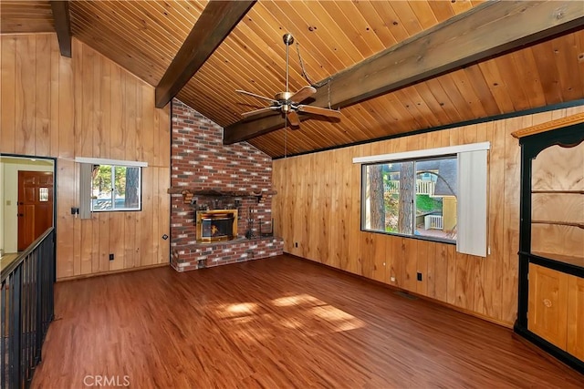 unfurnished living room with wood ceiling, plenty of natural light, lofted ceiling with beams, and hardwood / wood-style flooring