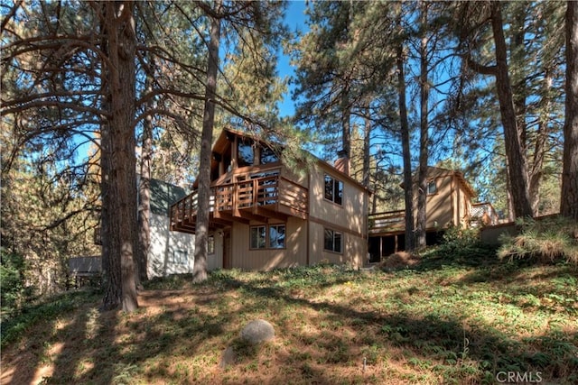 rear view of house featuring a deck