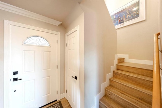 entrance foyer featuring ornamental molding and hardwood / wood-style flooring