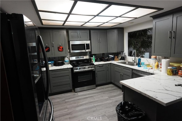 kitchen with sink, gray cabinetry, and black appliances