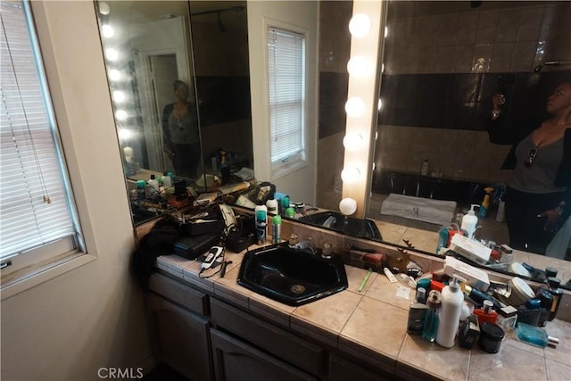 bathroom featuring tile patterned flooring and vanity