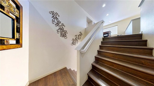 stairway with hardwood / wood-style floors