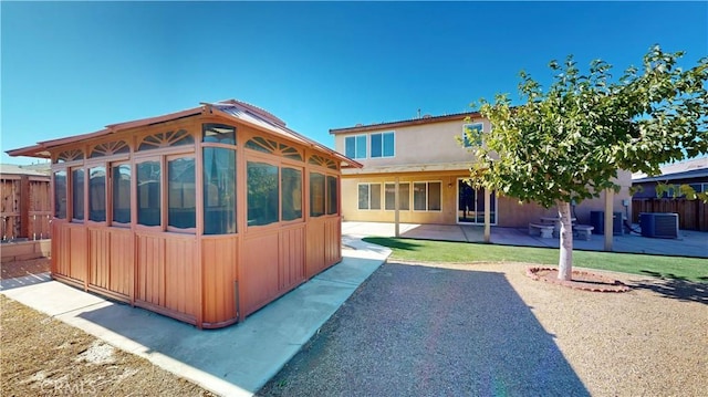 back of property featuring a patio and central AC