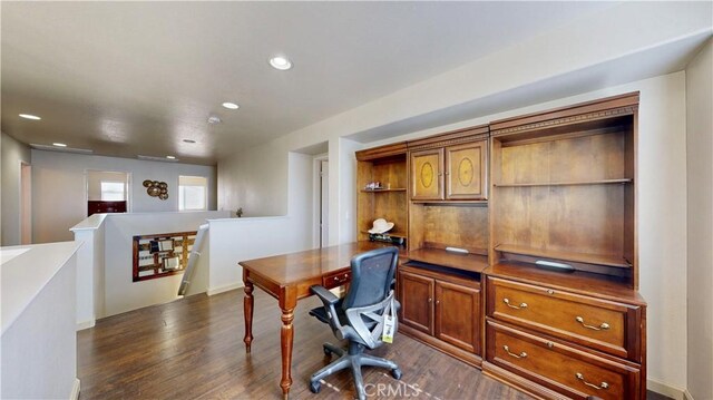 home office featuring built in desk and dark wood-type flooring