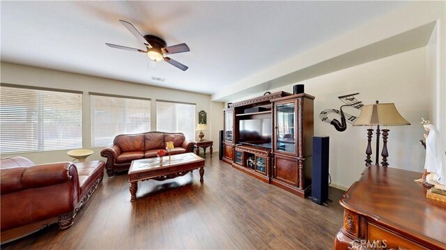 living room with ceiling fan and dark wood-type flooring