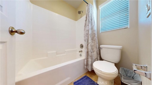 bathroom with shower / tub combo with curtain and toilet