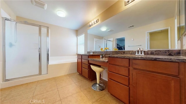 bathroom featuring tile patterned flooring, vanity, and separate shower and tub