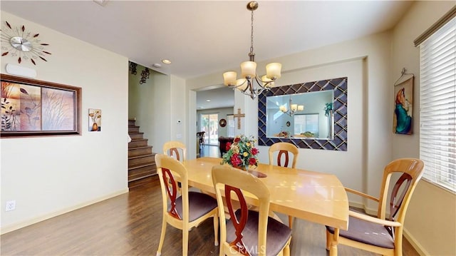 dining space with a chandelier and wood-type flooring