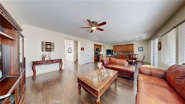 living room with ceiling fan and dark hardwood / wood-style floors