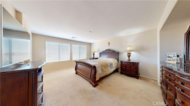 carpeted bedroom with multiple windows