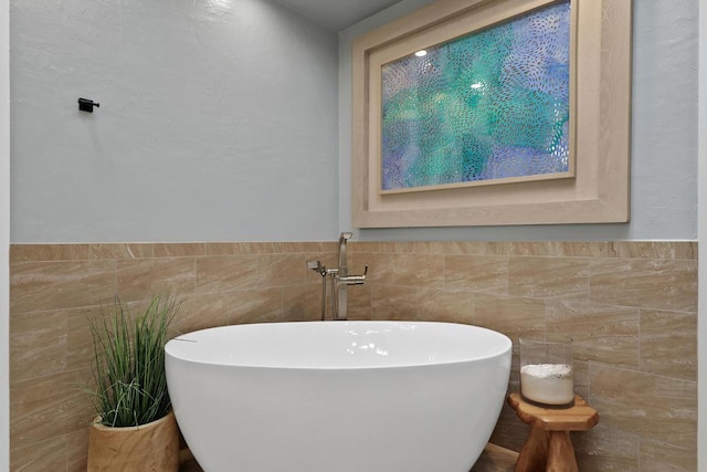 bathroom featuring a tub and tile walls