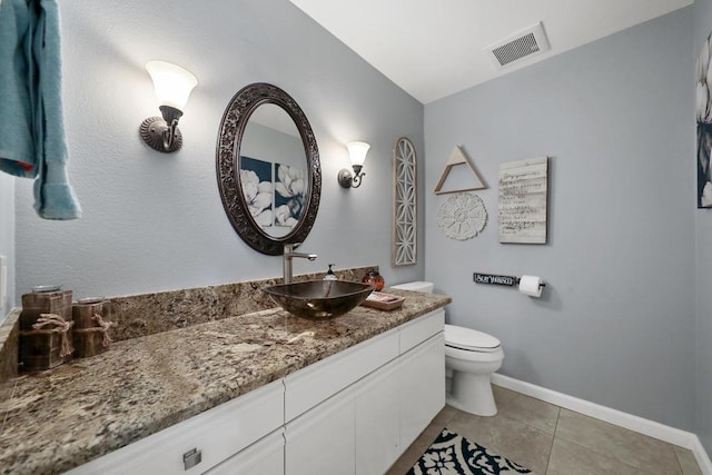 bathroom with tile patterned flooring, vanity, and toilet