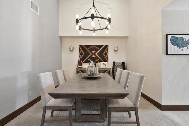 dining space with light tile patterned floors and an inviting chandelier