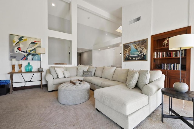 living room featuring light carpet and a towering ceiling