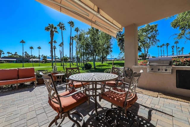 view of patio with area for grilling and exterior kitchen