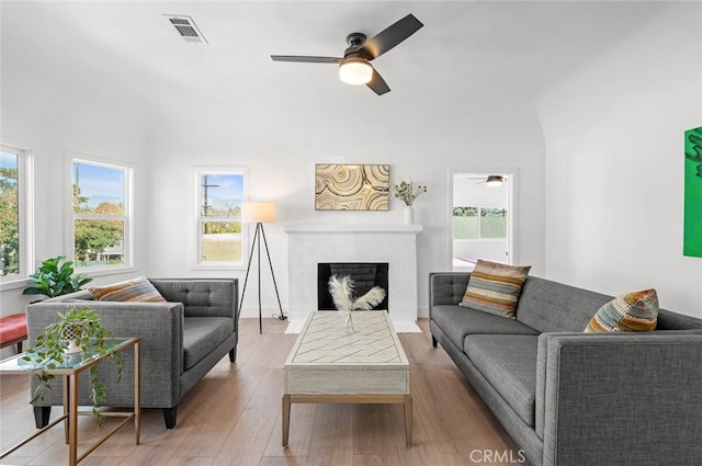 living room featuring ceiling fan and light wood-type flooring