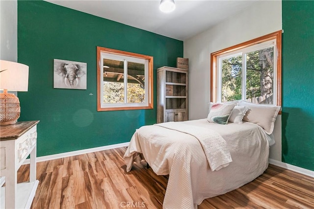 bedroom with wood-type flooring