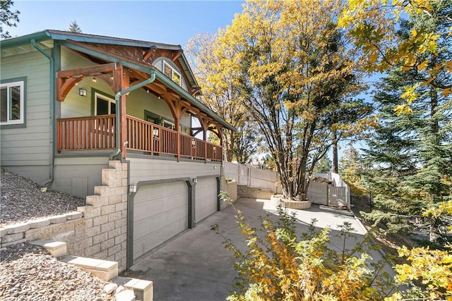 view of side of home with a balcony and a garage