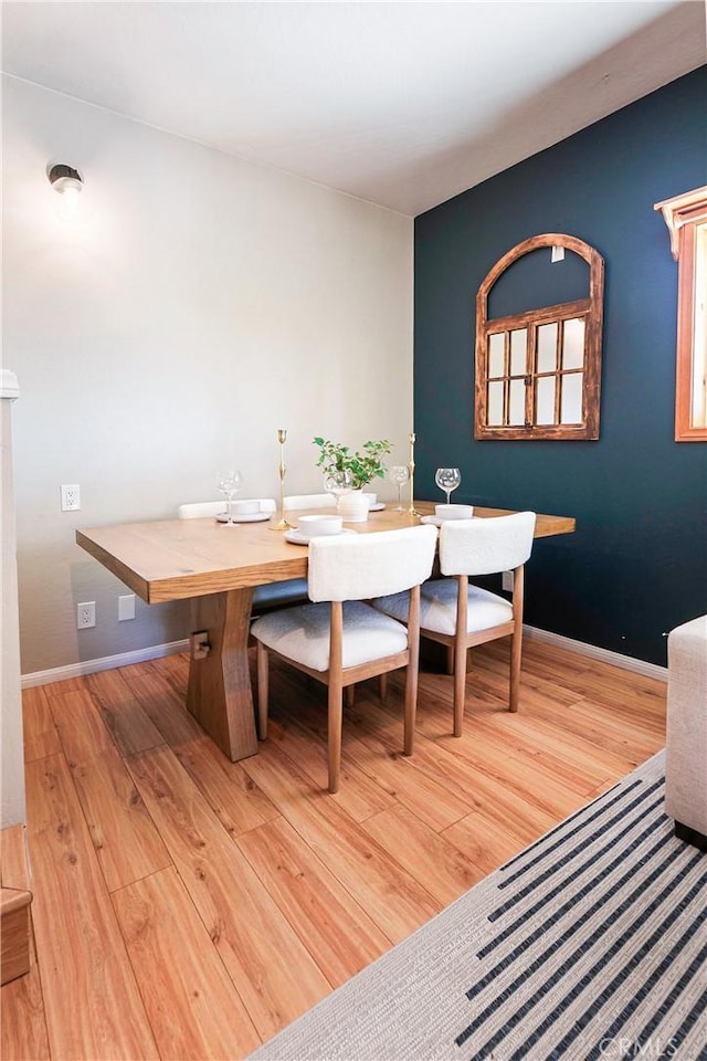 dining space with light hardwood / wood-style floors