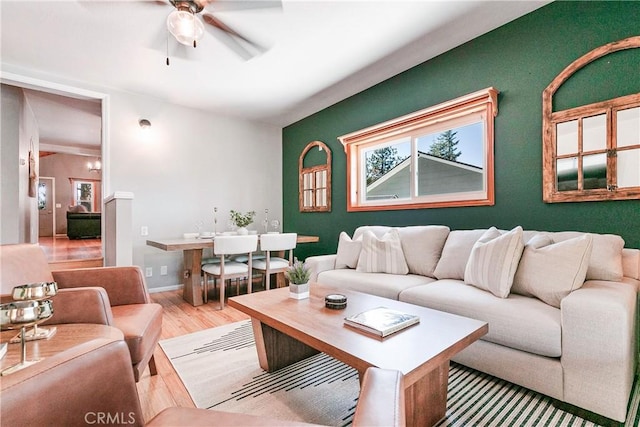 living room featuring light hardwood / wood-style flooring and ceiling fan