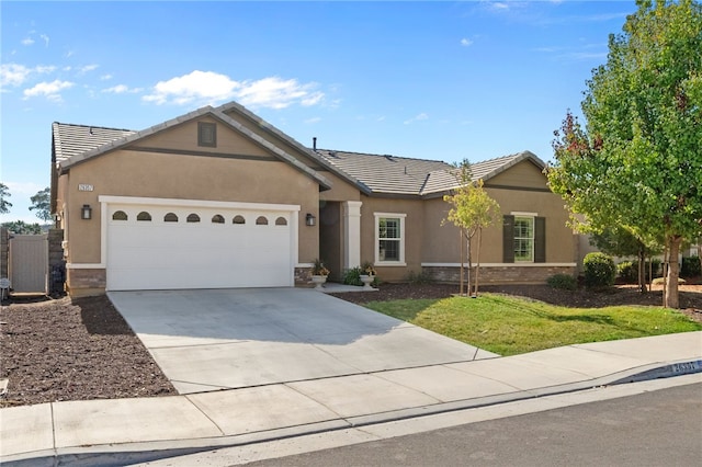 single story home featuring a front lawn and a garage