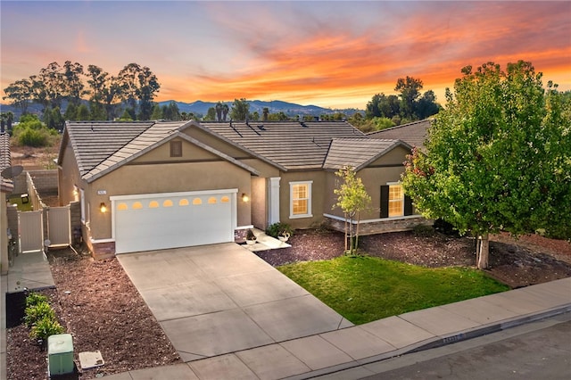 ranch-style house with a mountain view and a garage