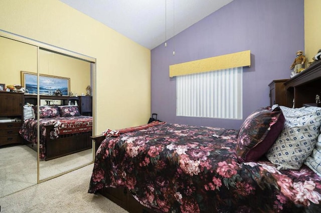 carpeted bedroom with a closet and lofted ceiling