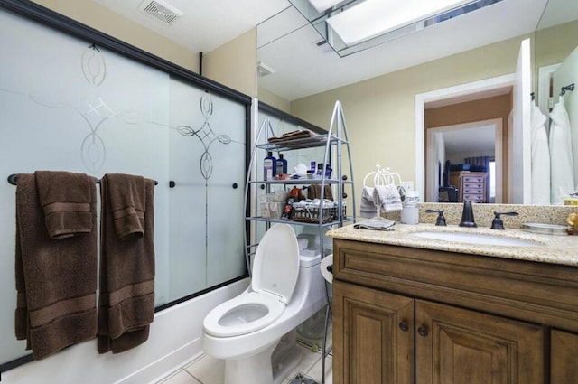 full bathroom featuring a skylight, vanity, shower / bath combination with glass door, tile patterned flooring, and toilet