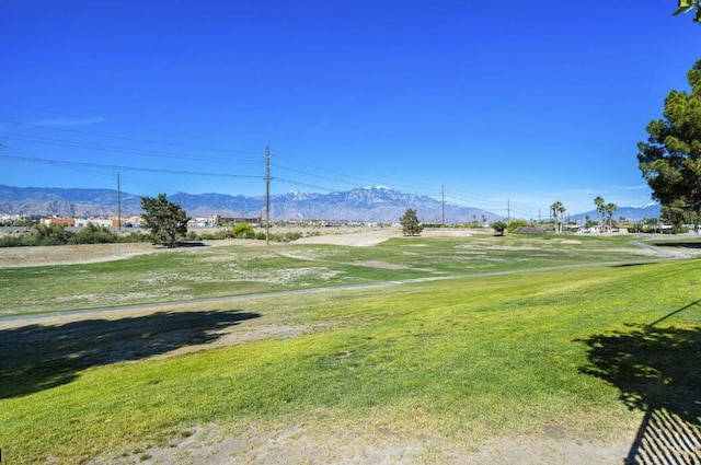 view of home's community featuring a lawn and a mountain view