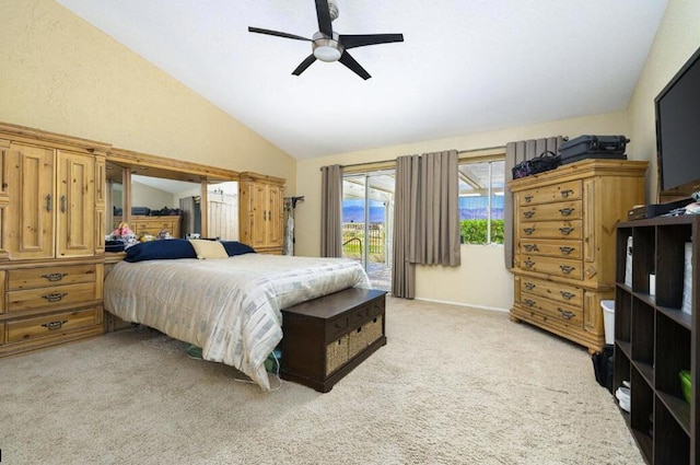 carpeted bedroom with access to exterior, ceiling fan, and vaulted ceiling