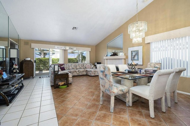 tiled dining space with vaulted ceiling and a chandelier