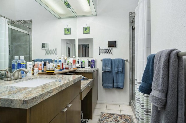 bathroom featuring tile patterned flooring, vanity, and a shower with shower door