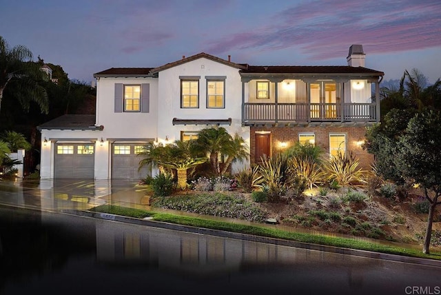 view of front of property with a garage and a balcony