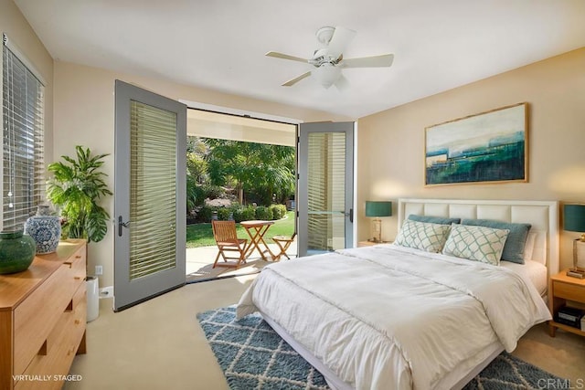 carpeted bedroom featuring ceiling fan, multiple windows, baseboards, and access to exterior