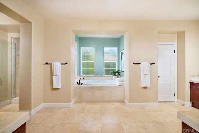 bathroom with tile patterned flooring, baseboards, a bath, and vanity