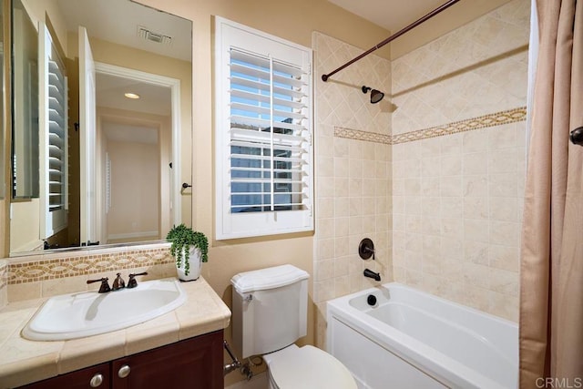 bathroom featuring bathtub / shower combination, visible vents, vanity, and toilet