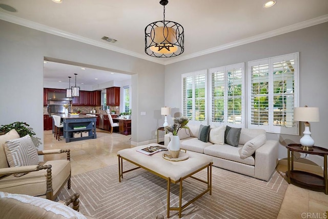 living area with a chandelier, visible vents, and crown molding