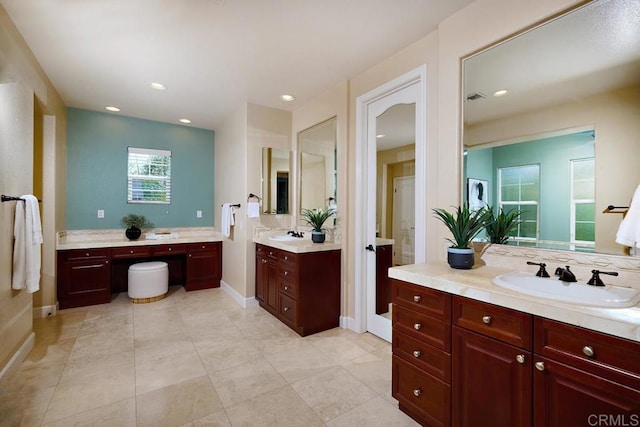 bathroom with recessed lighting, two vanities, a sink, baseboards, and visible vents