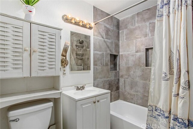 full bathroom with shower / bath combo with shower curtain, vanity, and toilet