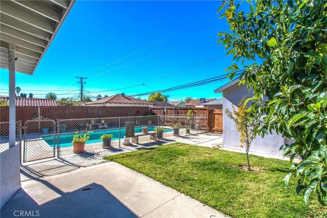 view of pool featuring a yard and a patio