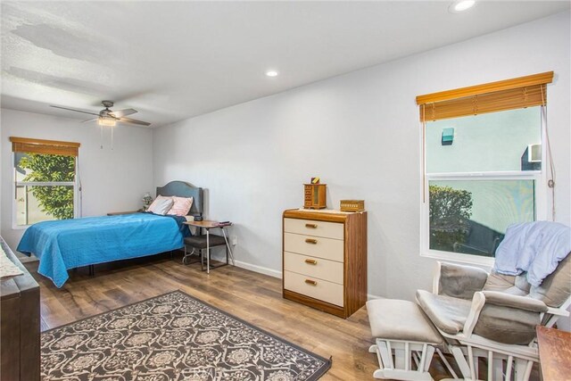 bedroom with hardwood / wood-style floors and ceiling fan