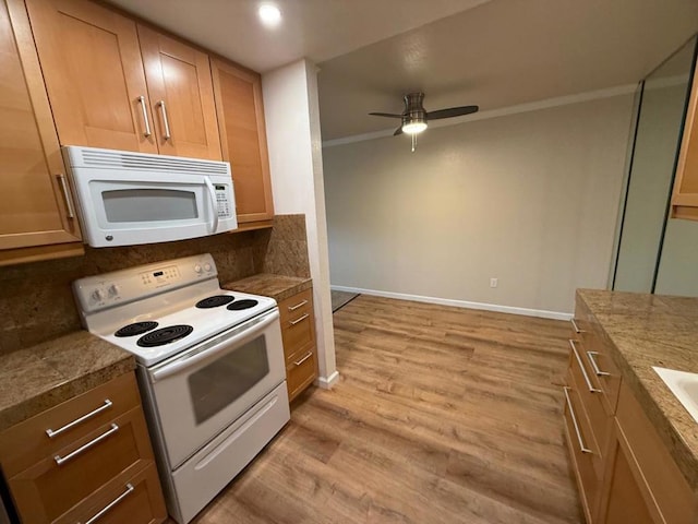 kitchen with crown molding, light wood-type flooring, ceiling fan, white appliances, and backsplash