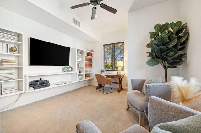 sitting room with light colored carpet and ceiling fan