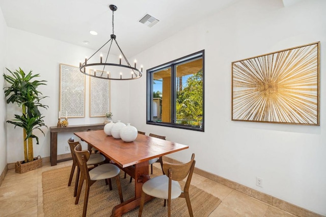 dining space with light tile patterned floors and an inviting chandelier